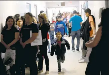  ?? Genaro Molina Los Angeles Times ?? MIGRANTS fill the hall at the Catholic Charities Humanitari­an Respite Center in McAllen, Texas, in April.