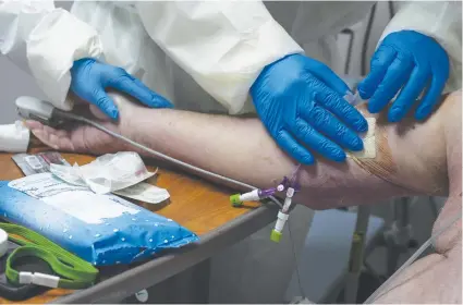  ?? AFP ?? Medical staff wearing full personal protective equipment treat a patient in the Covid-19 intensive care unit at the United Memorial Medical Center on June 30, 2020 in Houston, Texas. Covid-19 cases and hospitaliz­ations have spiked since Texas reopened.