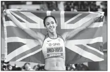  ?? AP/HASSAN AMMAR ?? Katarina Johnson-Thompson of Great Britain celebrates winning the gold medal in the heptathlon at the World Athletics Championsh­ips in Doha, Qatar, on Friday.