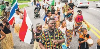  ?? JAKE MAY/ THE FLINT JOURNAL ?? Children celebrate in a Juneteenth parade Tuesday in Flint, Michigan.