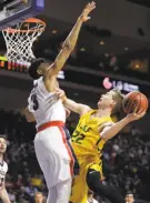  ?? Isaac Brekken / Associated Press ?? USF’s Chase Foster tries to shoot over Gonzaga’s Johnathan Williams.