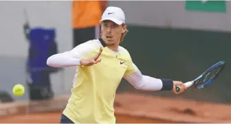  ?? YVES HERMAN/REUTERS ?? Denis Shapovalov keeps his eye on the ball at the French Open on Tuesday. The Canadian lost in the opening round to Danish teenager Holger Rune 6-3, 6-1, 7-6(4).