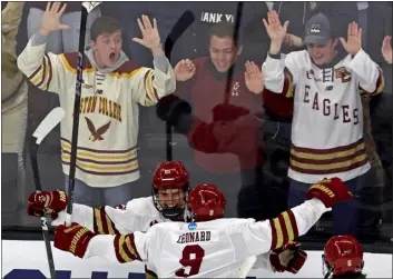  ?? STAFF PHOTO — STUART CAHILL/BOSTON HERALD ?? Boston College forward Oskar Jellvik celebrates his goal with forward Ryan Leonard (9) and the fans during NCAA Tournament action Friday. BC skated past Michigan Tech, 6-1, in Providence, R.I.