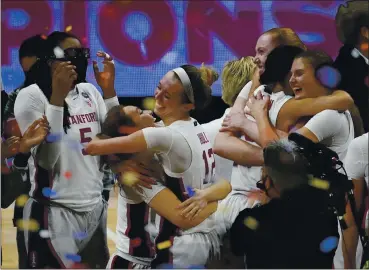  ?? ERIC GAY — THE ASSOCIATED PRESS ?? Stanford players celebrate at the end of the NCAA Women’s Championsh­ip Game on Sunday at the Alamodome in San Antonio. Stanford won 54-53, giving the team its first national championsh­ip since 1992.