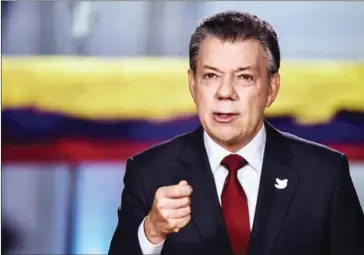  ?? PRESIDENCI­A COLOMBIA/AFP ?? Colombian President Juan Manuel Santos announces on Tuesday in Bogota that the government and FARC guerrillas will sign a new peace accord today.