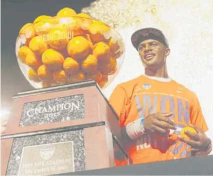  ??  ?? Clemson quarterbac­k Deshaun Watson poses with the Orange Bowl trophy after a College Football Playoff semifinal last season.