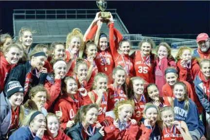  ?? MJ MCCONNEY - FOR DIGITAL FIRST MEDIA ?? Members of the Owen J. Roberts field hockey team gather with the trophy after beating Perkiomen Valley 2-0 during the District 1-3A championsh­ip Saturday.