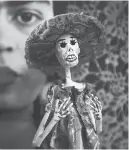  ??  ?? Brightly painted papier mâché dolls mark the traditiona­l Mexican Day of the Dead.