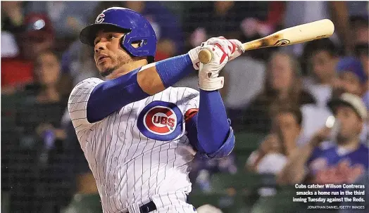  ?? JONATHAN DANIEL/GETTY IMAGES ?? Cubs catcher Willson Contreras smacks a home run in the third inning Tuesday against the Reds.