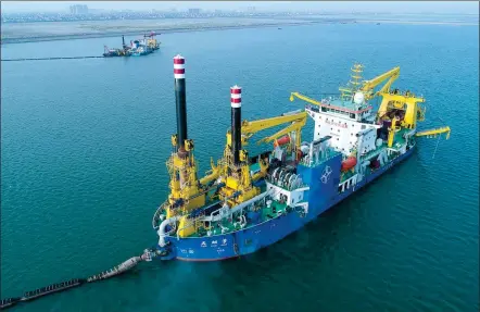  ?? XINHUA ?? Tian Kun Hao, owned by CCCC Tianjin Dredging Corp Ltd, carries out dredging operation in the offshore waters off the Chinese mainland. It is the largest heavy-duty self-propelled winch suction vessel in Asia.
