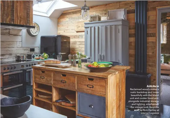  ??  ?? Kitchen Reclaimed wood creates a rustic backdrop and tones beautifull­y with the island unit and cooker hood and, alongside industrial storage and lighting, emphasises the vintage look. Bespoke wall by Nick Hartley at Interior Logistics