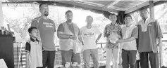  ??  ?? Muhammad Afiq (third left) and PAS Sibuti members distribute some goodies to the residents in Kuala Niah.