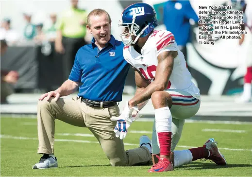  ??  ?? New York Giants defensive coordinato­r Steve Spagnuolo (left) talks with Roger Lewis prior to an NFL game against the Philadelph­ia Eagles. — All photos/ Ti Gong