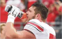  ?? DAVID JABLONSKI / STAFF ?? Ohio State’s Josh Myers gets a drink before the spring game on April 13 at Ohio Stadium in Columbus. The Miamisburg High School grad will start at center for the Buckeyes.