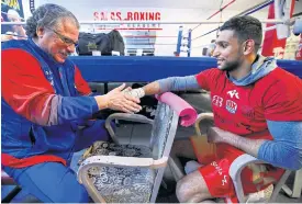  ??  ?? Jacob Duran, left, works with Amir Khan.