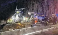  ?? MATTHIEU FERRI/FRANCE BLEU VIA AP ?? In this photo provided by France Bleu, rescue workers help after a school bus and a regional train collided in the village of Millas, southern France, Thursday. A school bus and a regional train collided in southern France on Thursday, killing four...