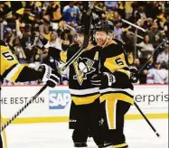  ?? Emilee Chinn / Getty Images ?? The Penguins’ Mike Matheson, right, celebrates his goal with Kris Letang in Monday’s Game 4 of a first-round playoff series against the Rangers.