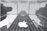  ?? Associated Press file photo ?? ■ The Apple logo hangs in the glass-box entrance to the company’s Fifth Avenue store on Sept. 5, 2014, in New York.