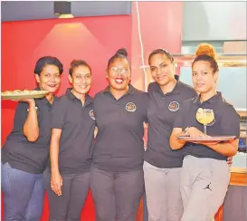  ?? Picture: JOVESA NAISUA ?? Grills Restaurant and Bar staff pose for a photograph during the opening of the restaurant in Suva on Wednesday.