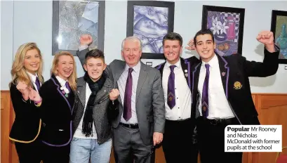  ??  ?? Popular Mr Rooney and Nicholas McDonald with former pupils at the school