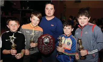  ??  ?? Ballydesmo­nd’s Eoghan O’Connor, Timmy Keane, Jack Buckley and Tomas Myers took victory in the senior category and received their prizes from Michael Murphy, Chairman, Dromtariff­e Juvenile GAA.