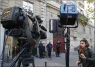  ?? MICHEL EULER — AP PHOTO ?? French police officers and a TV crew stand outside the residence of Kim Kardashian West in Paris Monday. Kim Kardashian West was unharmed after being robbed at gunpoint of more than $10 million worth of jewelry inside a private Paris residence Sunday...