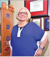  ??  ?? Brenda Rodgers, Bryant High School counselor, displays her college diplomas and awards on the wall in her office. She also displays her motto: E+R=O on the side of her bookcase (see story for explanatio­n). Rodgers has been named the Southwest Region...