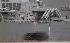  ??  ?? The damaged port aft hull of the USS John S. McCain, is visible while docked at Singapore’s Changi naval base on Tuesday in Singapore. AP PHOTO/WONG MAYE-E