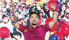  ?? AP ?? Senator Manny Pacquiao raises his hands during a national convention of his PDP-Laban party in Quezon City.