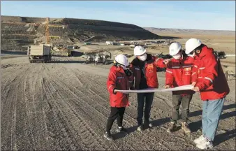  ?? XINHUA ?? Engineers from China Gezhouba Group Corp discuss plans for two hydropower stations at a constructi­on site in Argentina in April.