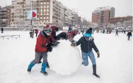  ?? GETTY
PABLO BLAZQUEZ DOMINGUEZ/ ?? Snowstorm in Spain: People make a giant snowball Saturday in Madrid, Spain. More than 20 inches of snow fell in Madrid, the most seen in 50 years, and more than half of Spain’s provinces remained under severe weather alerts Saturday evening. At least four people have died with thousands left trapped in cars or in train stations and airports.