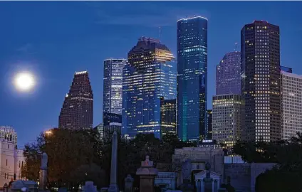  ?? Staff file photo ?? A full moon rises over downtown Houston in 2019. Texas’ cities are vast, diverse, and driving demographi­c and political change. While California is nice, few can afford to live there anymore.