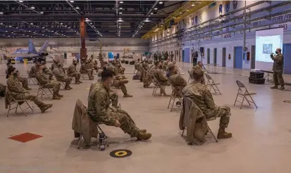  ?? PHOTOS : IMAGERIE M2 DUGUAY ?? Les participan­ts à l’exercice AMALGAM DART ont dû se soumettre à des mesures sanitaires strictes en raison de la pandémie de COVID-19. Ici les militaires canadiens et américains suivent la présentati­on de bienvenue et de sécurité du Lcol Gendreau, à bonne distance les uns des autres dans un hangar de la BFC Goose Bay.