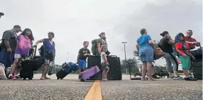  ?? Picture / AP ?? Evacuees stand in line at the Germain Arena, which is being used as a shelter, in Estero, Florida.