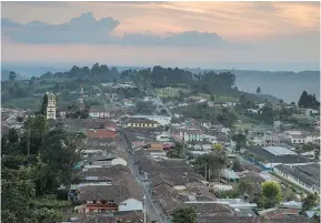  ?? — GETTY IMAGES FILES ?? Salento, Colombia is a town of about 7,500 people living along a steeply canted grid of paved streets more than a mile (1.6 km) above sea level.