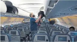  ?? JONATHAN HAYWARD THE CANADIAN PRESS ?? Airlines and airports around the world are taking safety measures to instill confidence in flyers; however, consistenc­y is still an issue, and it’s unclear whether these efforts will be enough.