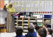  ?? PRESS VIA AP GRAHAM HUGHES / THE CANADIAN ?? Kindergart­en teacher Haniyfa Scott gives a lesson during class in Montreal on April 4.