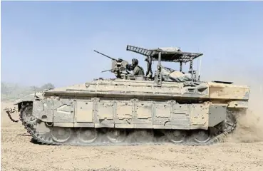  ?? /Amir Levy/Getty Images (Page 5 and 11) ?? Security: An Israeli personnel carrier on the move near the border with the Gaza Strip on Monday. Israel’s allies have urged the country to avoid an escalation of conflict after Iran launched hundreds of missiles and drones at the weekend.