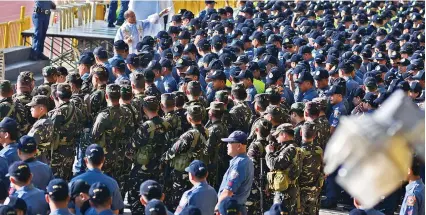  ?? SUNSTAR / AMPER CAMPAÑA ?? PRAYERS BEFORE POLLS. A priest blesses the troops during the send-off ceremony held at the Cebu City Sports Center yesterday before their deployment to help secure this Monday’s elections.