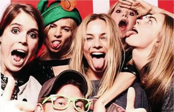  ??  ?? Popular princess (clockwise from left): Eugenie with Sienna Miller, Margot Robbie, Poppy Jamie, Cara Delevingne and Prince Harry in a photobooth snap