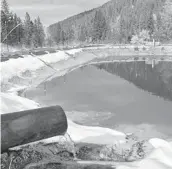  ?? MATTHEW BROWN/AP 2018 ?? Water contaminat­ed with arsenic, lead and zinc flows from a pipe out of the Lee Mountain mine and into a holding pond near Rimini, Montana.