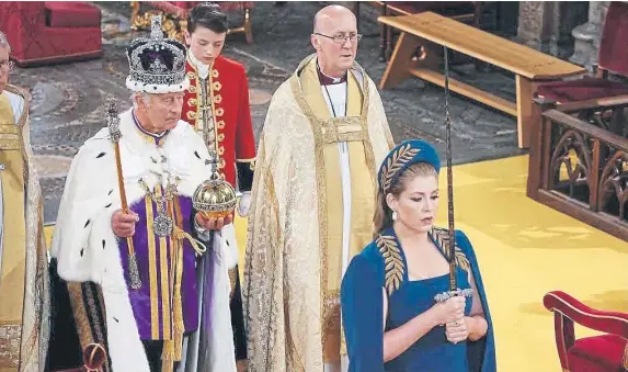  ?? ?? Lord President of the Council, Penny Mordaunt, holding the Sword of State walking ahead of King Charles III during the coronation
Picture: Yui Mok - WPA Pool/Getty Images