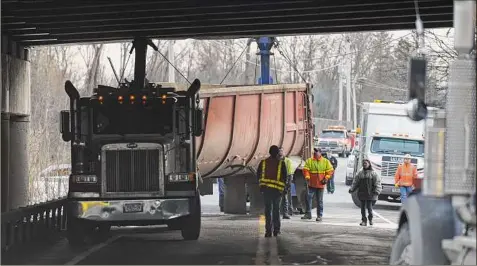  ?? Skip Dickstein / Times Union ?? Inspectors for the State Thruway investigat­e an accident Dec. 14, 2009, on Route 144 in Coeymans, after a dump truck struck one of the bridges..