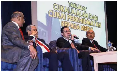  ??  ?? Taxing tasks ahead: (From left) Subromania­m, Treasury deputy secretaryg­eneral Datuk Ahmad Badri Mohd Zahir, Lim and Roslan at the SST media briefing in Putrajaya.