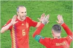  ?? OZAN KOSE/AFP/GETTY IMAGES ?? Spain's Andres Iniesta, left, and Sergio Ramos celebrate their side’s second goal on Monday.