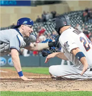  ?? JIM MONE THE ASSOCIATED PRESS ?? Blue Jays catcher Danny Jansen tags out the Minnesota Twins’ C.J. Cron in a Toronto win this week. The 24-year-old rookie is in his first season as a primary catcher in the major leagues.