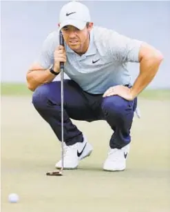  ?? GETTY ?? Rory McIlroy lines up putt for birdie on eighth green Thursday.