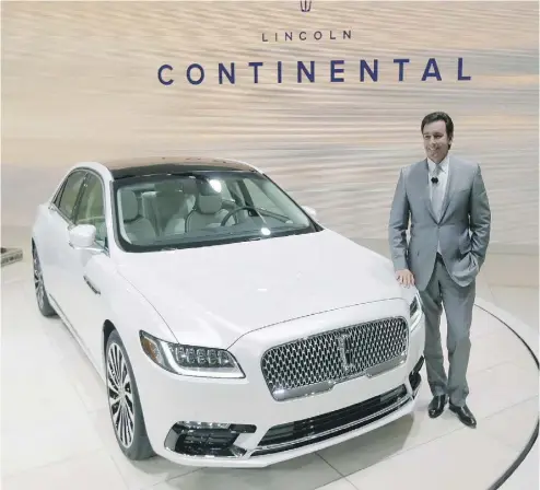  ?? CARLOS OSORIO / AP PHOTO ?? Mark Fields, Ford Motor Co. president and CEO, stands next to the 2017 Lincoln Continenta­l at the Detroit auto show.
The production version of the Continenta­l looks like a Chrysler 300 redesigned by Liberace, writes David Booth.