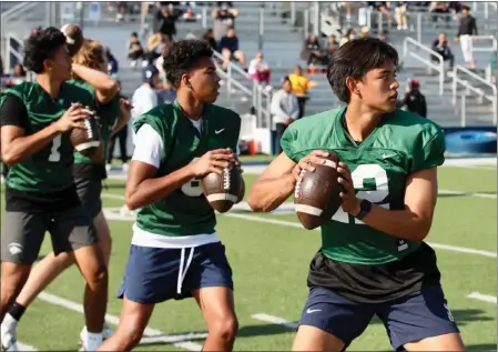  ?? PHOTOS BY HOWARD FRESHMAN ?? Junior Caleb Sanchez, right, and the three other quarterbac­ks have been training with a virtual reality platform in hopes of improving their performanc­es.