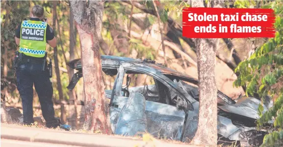  ?? Picture: GLENN CAMPBELL ?? NT Police crash investigat­ors at the scene of the crash on Dick Ward Drive, after the taxi had burst into flames.